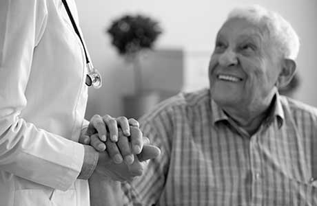 An older man talking to a doctor