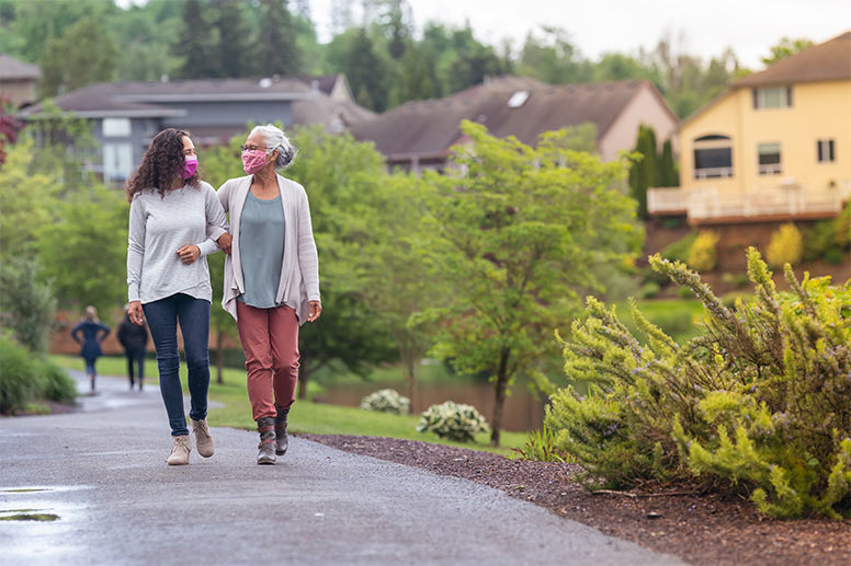 Mother daughter walking with masks on